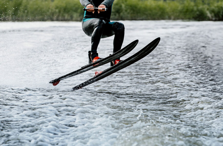 Man waterskiing on lake behind