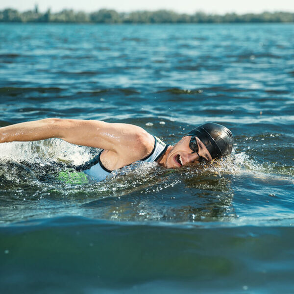 Professional triathlete swimming in river